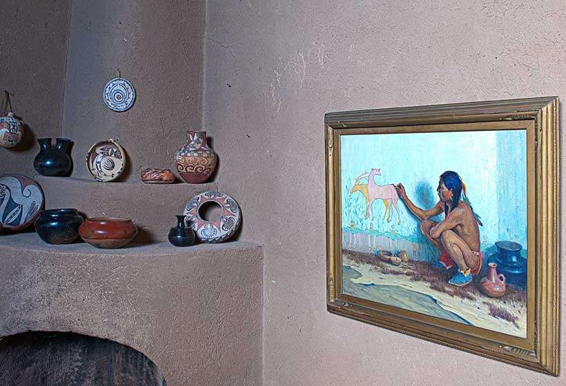 Corner fireplace with his painting "Indian Artist."