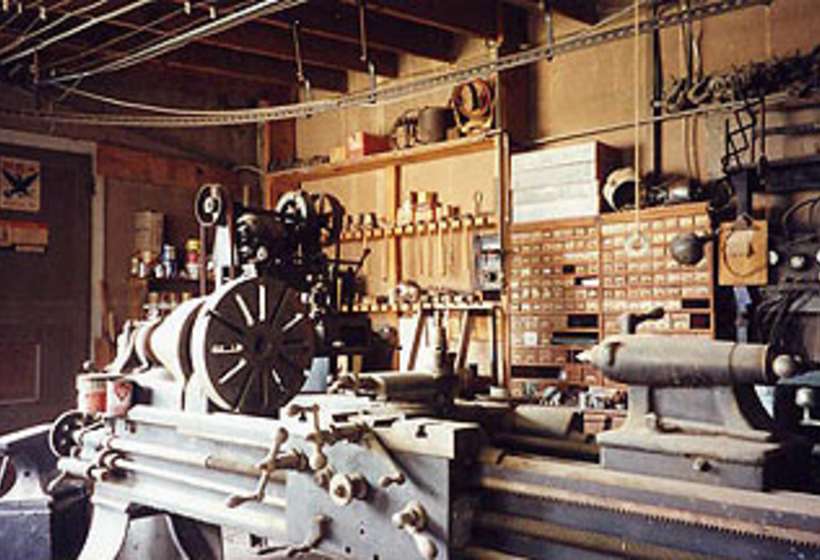 Close up of large metal lathe in Kibbey’s machine shop.